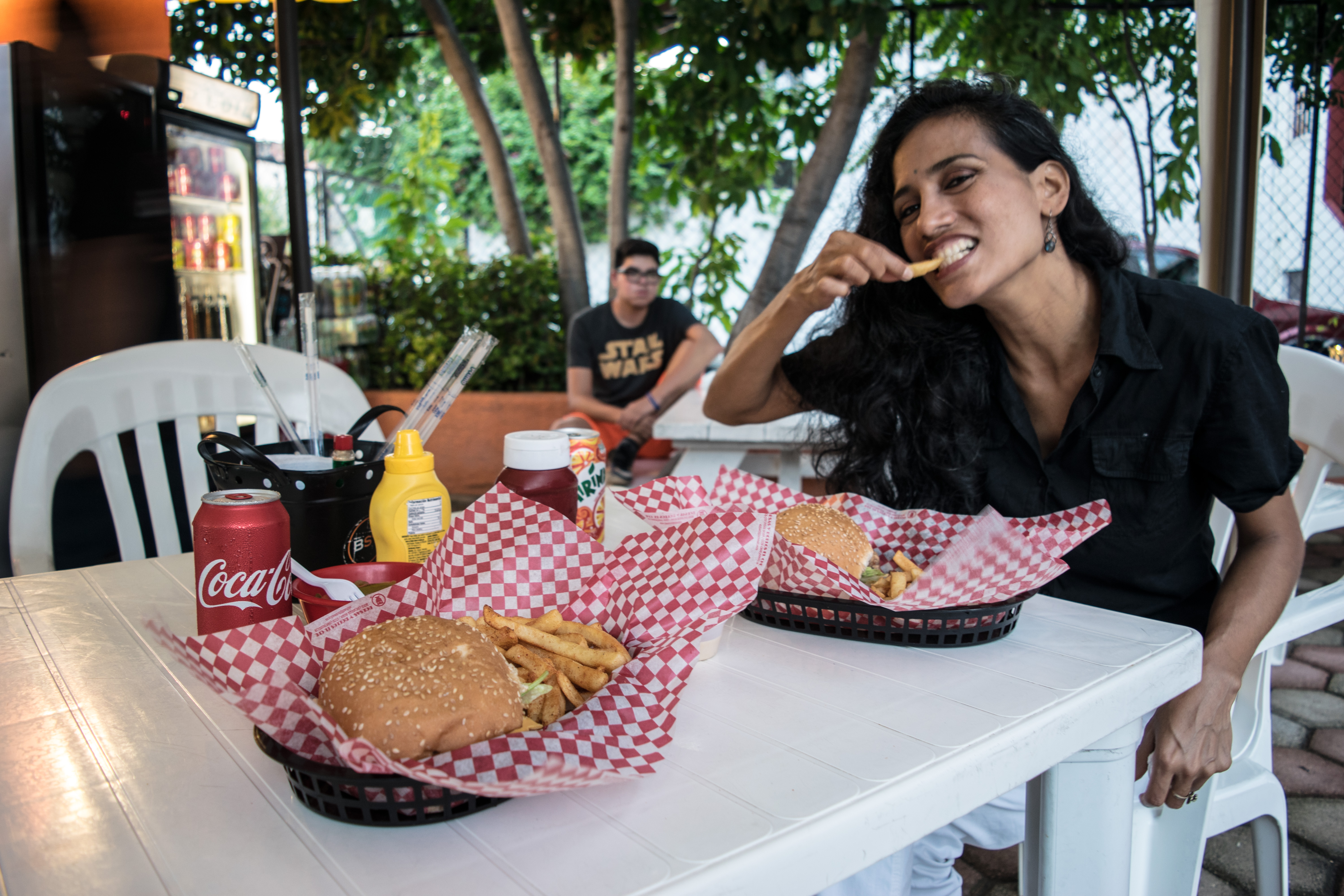 cris enjoying a burger in cancun