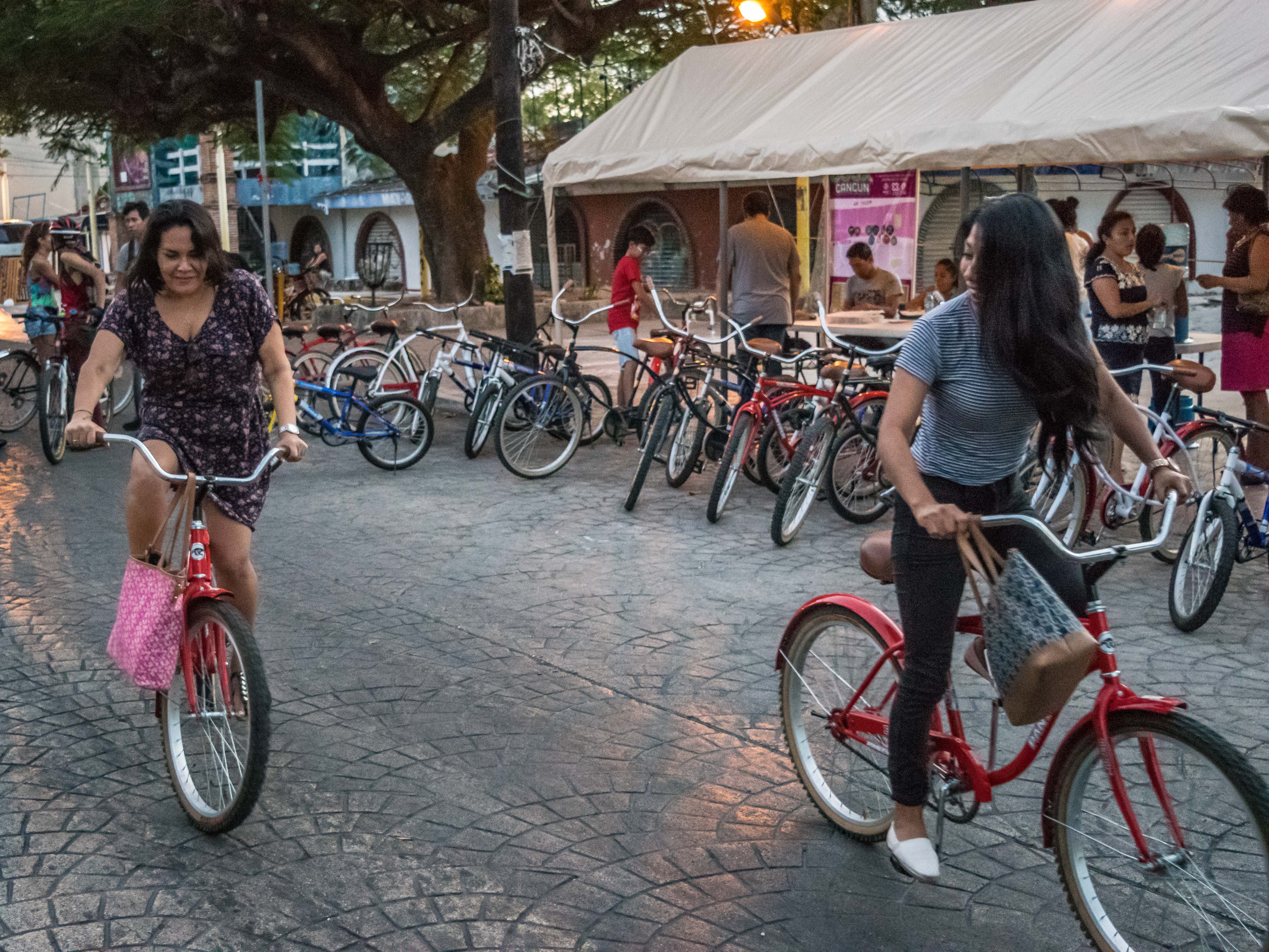 Girls on bikes at Co'ox event in Cancun